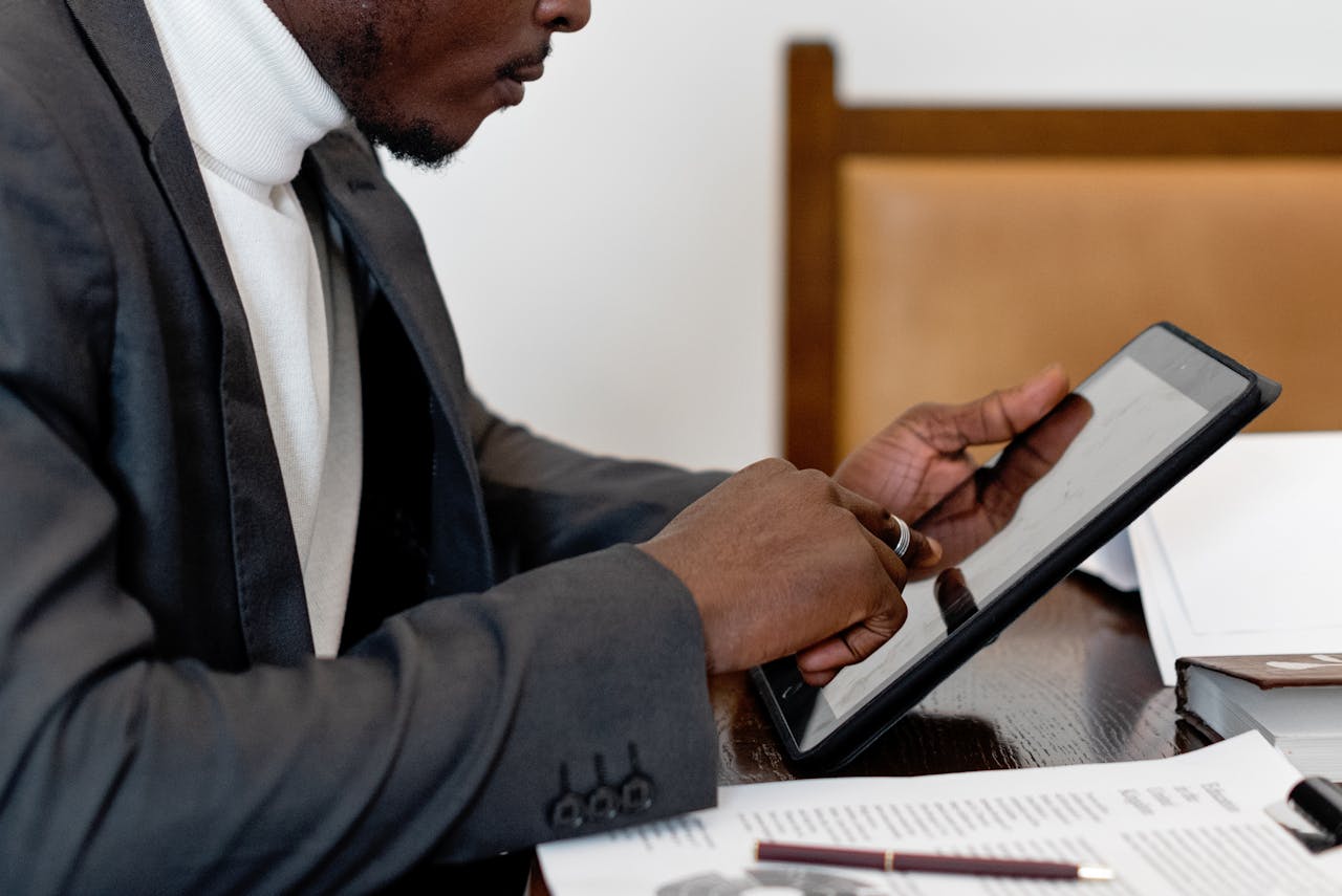 Man signing on tablet